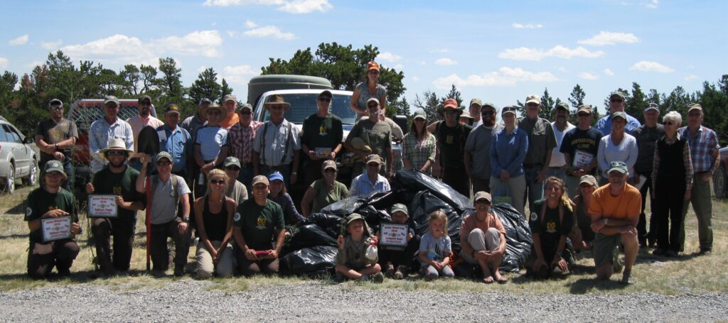 Volunteers pose by the bags of weeds collected during the Teton Canyon Weed Pull.